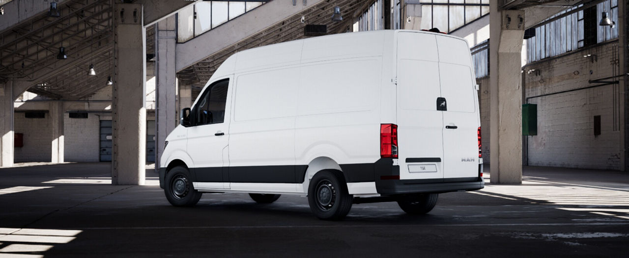 Rear three-quarter view of a white MAN delivery van parked indoors.