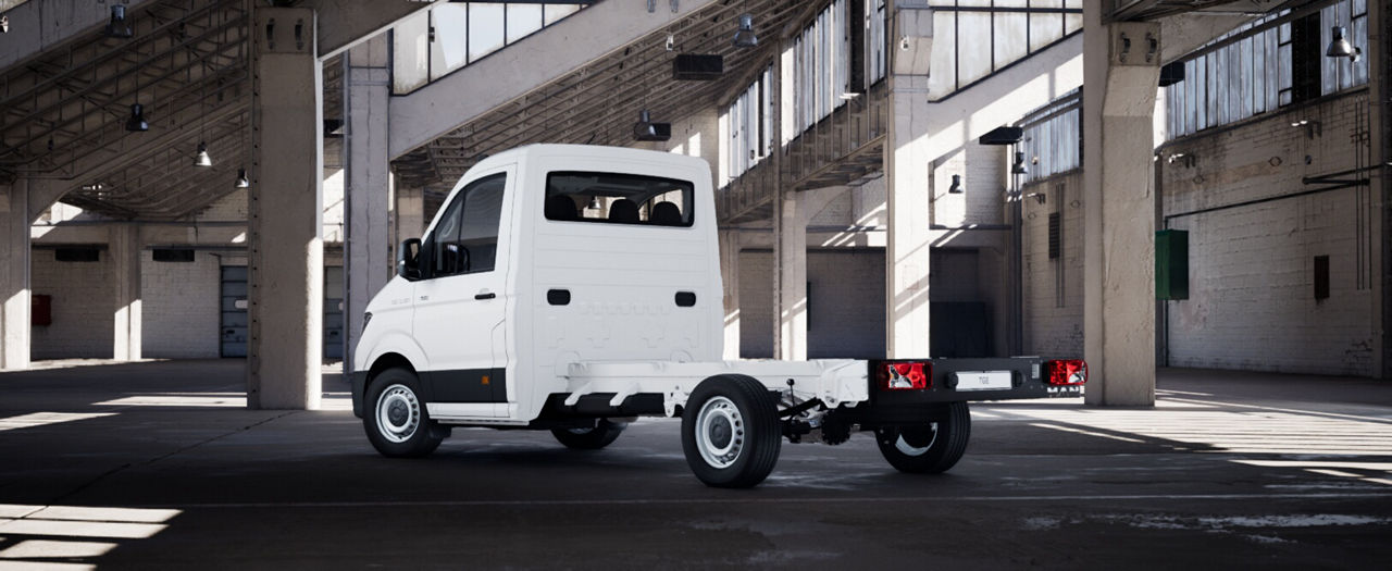 Rear three-quarter view of a white MAN chassis cab vehicle without cargo body.