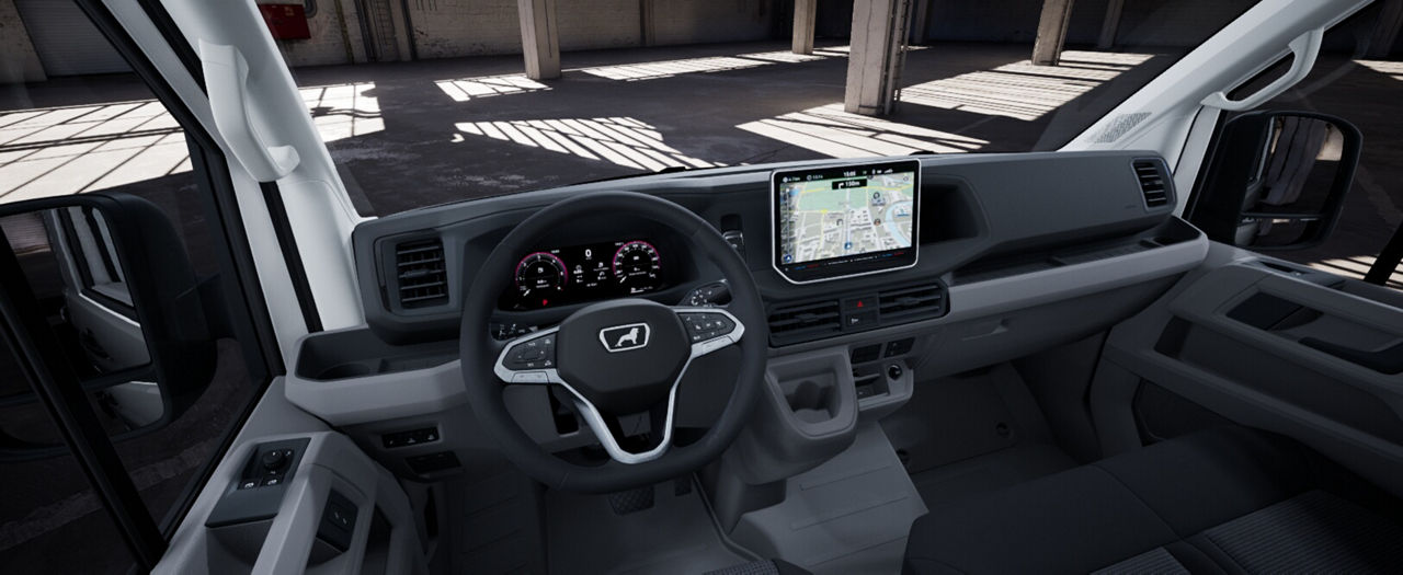 Driver’s cockpit of a MAN commercial vehicle with steering wheel, instrument cluster, and navigation screen.”