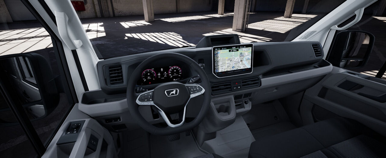 Interior cockpit of a MAN van showing steering wheel, dashboard, and navigation screen