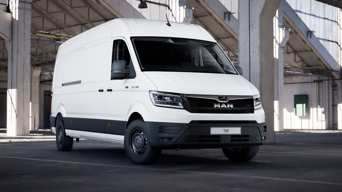Front three-quarter view of a white MAN cargo van parked inside an industrial warehouse