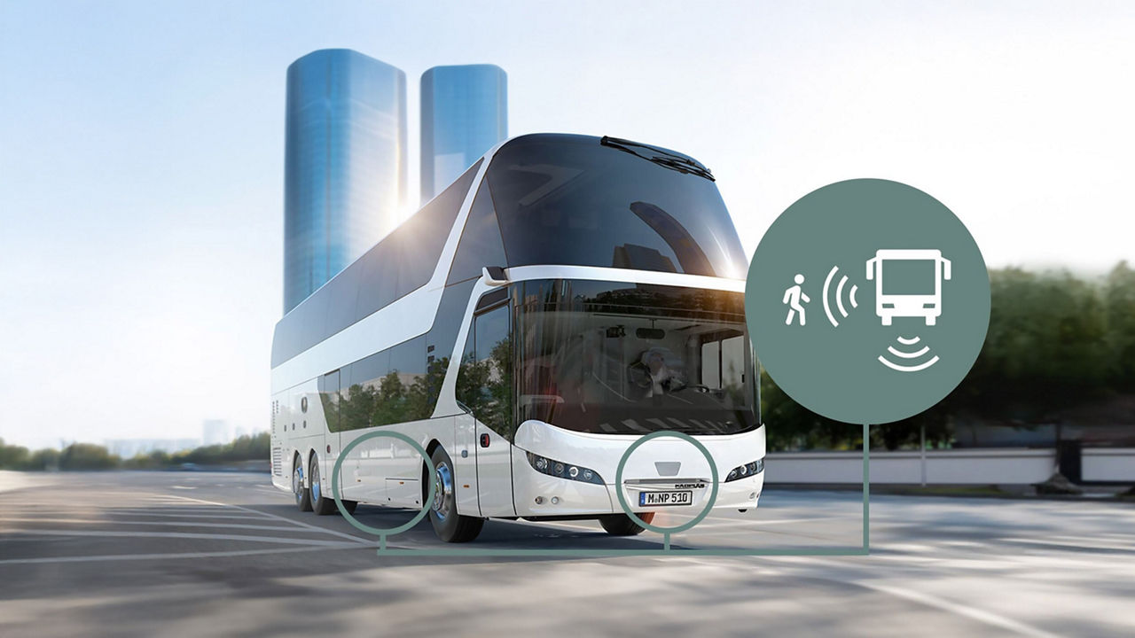 Modern NEOPLAN coach bus with a symbol for active turning assist and pedestrian detection using camera technology, enhancing road safety.