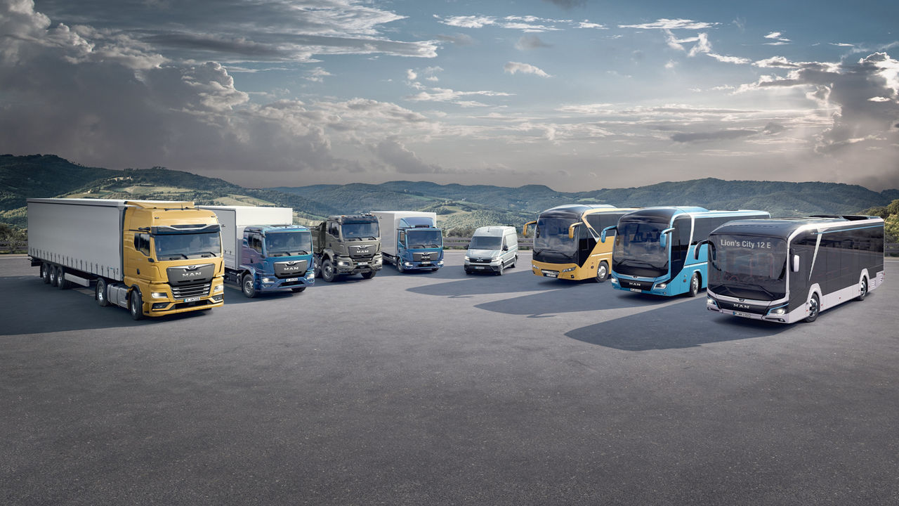 MAN vehicles lined up in front of an alpine landscape